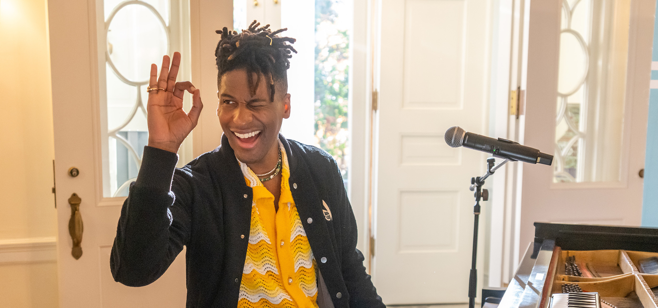 Jon Batiste at Carr's Hill winking at the camera before playing a teaser of a new song