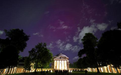 The Northern Lights show pink tones over the Rotunda