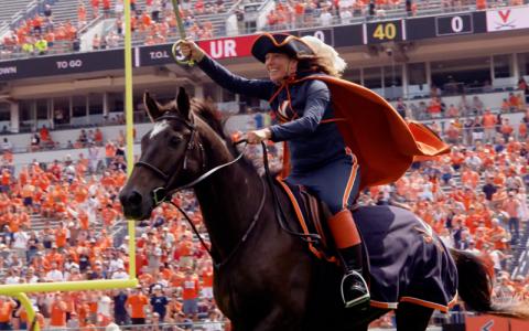 Cavalier riding on horseback at a football game